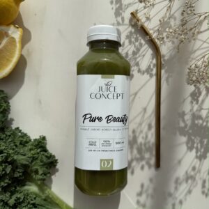 PURE BEAUTY Juice Concept – świeżo wyciskany zielony sok Cold Press z jarmużem, jabłkiem, korzeniem selera i cytryną, zamknięty w eleganckiej szklanej butelce premium. Na zdjęciu widoczny jest naturalny zielony sok o intensywnym kolorze charakterystycznym dla świeżych warzyw bogatych w chlorofil. PURE BEAUTY to zielony sok na zdrową skórę, stworzony z myślą o kobietach 35+, które chcą wspierać promienny wygląd, regenerację i dobre samopoczucie poprzez codzienną dietę. Jarmuż jest źródłem naturalnych antyoksydantów i składników odżywczych, a cytryna dostarcza witaminy C wspierającej prawidłową produkcję kolagenu. Jabłko nadaje sokowi naturalną, delikatną słodycz, natomiast korzeń selera wzbogaca jego warzywny profil. Sok jest świeżo wyciskany metodą Cold Press wyłącznie z naturalnych warzyw i owoców, bez dodatku cukru, konserwantów i sztucznych dodatków. PURE BEAUTY wpisuje się w filozofię beauty from within – świadomego wspierania skóry i organizmu od środka. Minimalistyczna estetyka zdjęcia podkreśla świeżość, czysty skład i premium charakter produktu Juice Concept. To naturalny zielony sok funkcjonalny dla kobiet dbających o zdrową skórę, dietę przeciwzapalną, mikrobiom, codzienną lekkość oraz świadomy styl życia.